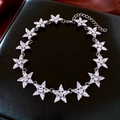 Detailed view of silver star-shaped necklace with white crystals on black leather - 21# Necklace-Silver