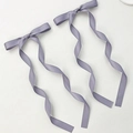 Detailed close-up of a pair of lavender ribbon bow hair clips with long spiral tails - Dark Purple (1 Pair)
