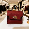 Miniature burgundy leather handbag keychain with 7.5cm dimensions and gold twist lock - Red Bag Style
