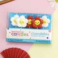 Five pack of white flower-shaped birthday candles with smiling faces in a clear box - Cartoon Smiley Flower Candle