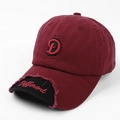 Close-up of embroidered letter D and Different text on distressed burgundy baseball cap - Maroon Black Brim (Maroon) / Burgundy