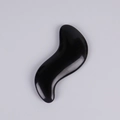Professional black resin S-shaped massage tool with polished finish on a grey background - S-Shape