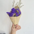 Detailed view of hand-held mini purple dried flower bouquet wrapped in vintage newspaper paper - Vintage Mini Purple Forget-me-not