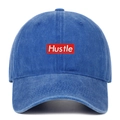 Detailed macro of vintage washed navy cotton baseball cap with red Hustle embroidery - One Size / Dark Blue