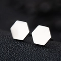 Minimalist silver hexagon stud earrings in polished stainless steel on black leather background - Hexagon / Silver