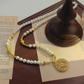 Collier de perles élégant avec pendentif doré évidé sur fond de livre ancien - Or/Blanc (X246)