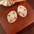 Macro shot of vintage round studs with cream enamel, red stones and iridescent gems - 925 Sterling Silver Earring Post Drip Oil Rhinestone Pearl Oval Stud Earrings