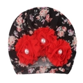 Close-up of floral baby turban hat with red fabric flowers and central pearl accents - D Black Red Floral
