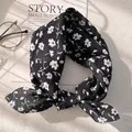 Detailed view of black floral cotton linen scarf with elegant white flower pattern - XY-23 Black White Floral