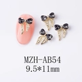 Gros plan de bijoux d'ongles nœuds dorés avec strass en cœur et détails de dimensions - Nœud Noir Obsidienne (AB54)