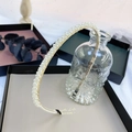 Elegant gold wavy headband with white pearls and rhinestones on black gift box background - Braided Pearls (Gold Braid Pearl)