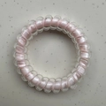 Pink lucky four-leaf clover spiral hair tie with a polka dot pattern phone cord design - Pink Core