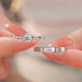 Silver moissanite engagement ring and matching wedding band set worn on a finger - Round Stone Women's Ring [1 Carat] Ljz-27 / Adjustable Open