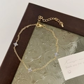 Detail of gold floral bracelet with purple petals on a vintage glass display tray - Clover Bracelet / Gold Blue