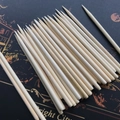 Bundle of natural pointed bamboo scratch tools for kids' art on a dark patterned board - 14cm Length
