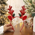 Red Christmas reindeer antler headband with bells and berries on a wooden desk - Mushroom Sequin Red