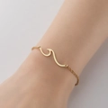 Elegant gold wave charm bracelet on wrist with minimalist circular link chain - 344-Wave / Steel
