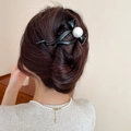 Elegant black bow hair claw clip with large center pearl shown on a model's hair - Bow Knot With Large Pearl Style (4# Grab Clip - Black)