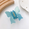 Translucent teal butterfly hair claw clip with golden spring on a minimalist setting - Sky Blue