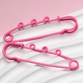 Close-up of pink lacquer coated 6cm safety pins with triple loop decorative metal design - Rose Red