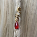 Detailed close-up of a vintage gold spiral hair accessory with a red teardrop pendant - Red Pendant