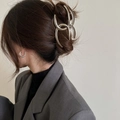 Macro detail of large silver metal hair claw clip with a glossy finish on a model - Silver Intertwined Lines (FJ0400)
