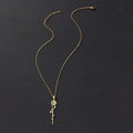Detail of gold rose pendant with custom cursive script name on a black background - June Birth Flower (Rose) / Gold