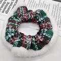 Close-up of Christmas scrunchie with red and green plaid fabric and white plush trim - Large Snowflake Green