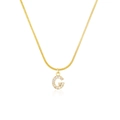 Macro detail of gold snake chain with crystal-encrusted letter G alphabet pendant - Letter G