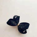 Macro shot of black corduroy bow hair clip with gold polka dots and centered golden wire - Black