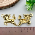 Golden alloy horse charms for DIY jewelry making shown with a ruler for size - Antique Gold Horse (19249)