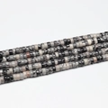 Close-up of mixed natural stone heishi spacer beads in assorted colors for jewelry - 3x6mm (110pcs) / Black Network Stone