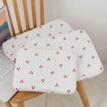 Close-up of three quilted cotton laptop sleeves with red cherry prints on cream fabric - Striped White with Cherry