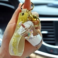 Creative liquid unicorn keychain featuring purple unicorn in a mini milk tea cup - White