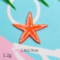 Macro shot of orange resin starfish accessory showing size dimensions 2.8x2.9cm and texture - Orange Thin Starfish