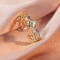 Detail of gold orbital ring with green gemstone and colorful crystals on pink silk - Multicolor Gem/Gold Vintage