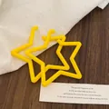 Detail showing bright yellow star acrylic earrings on a rustic wood and linen surface - 35# Silver Pin - Yellow - Hollow Pentagram