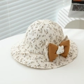 Detailed close-up of a floral baby sun hat with a brown bow and cute plush bunny ornament - 50cm (1-3 Years) / Khaki Floral