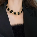 Vintage style necklace with black triangle beads on a gold chain worn by a model - Black Crystal Geometric Necklace (10#)