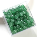 Macro shot of green round glass jelly jade beads in a box for DIY jewelry making - Dark Green Apple Bead