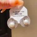 Vue macro d'une boucle d'oreille nœud en argent 925 avec perle et détails d'étiquette - Tige en Argent 925 - Perle Vortex Géométrique Argentée