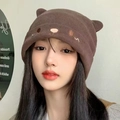 Brown knit beanie with cute bear ears and facial embroidery on a female model - Coffee Bear Ear Style