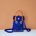 Detailed knit texture of a blue vertical mobile bag with orange ring handle and eyes - Snake Emoji (Blue)