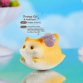 Macro detail of cute orange cat resin figurine with raw purple amethyst crystal inlay - 1244-1 Orange Cat Amethyst