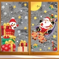Christmas window stickers set featuring Santa, reindeer, and snowflakes on a glass window - 2-Sheet Set XC063+XC064