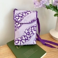 Mini purple knitted crossbody phone bag with irregular patterns on green book display - Zebra Purple
