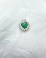 Detailed view of a silver heart pendant with a green center stone and clear zircons - Silver & Green