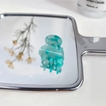 Mini acetate hair claw clip with blue-green marble texture on a mirror surface - Floral Green