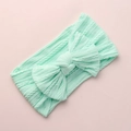 Detailed view of mint green cable knit baby headband with a large decorative soft bow - Emerald Green