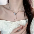 Silver butterfly pearl necklace with star fringe pendants shown on a female model - 5703714174776 / Minimalist Butterfly Pearl Star Tassel Necklace (X3675) / Silver